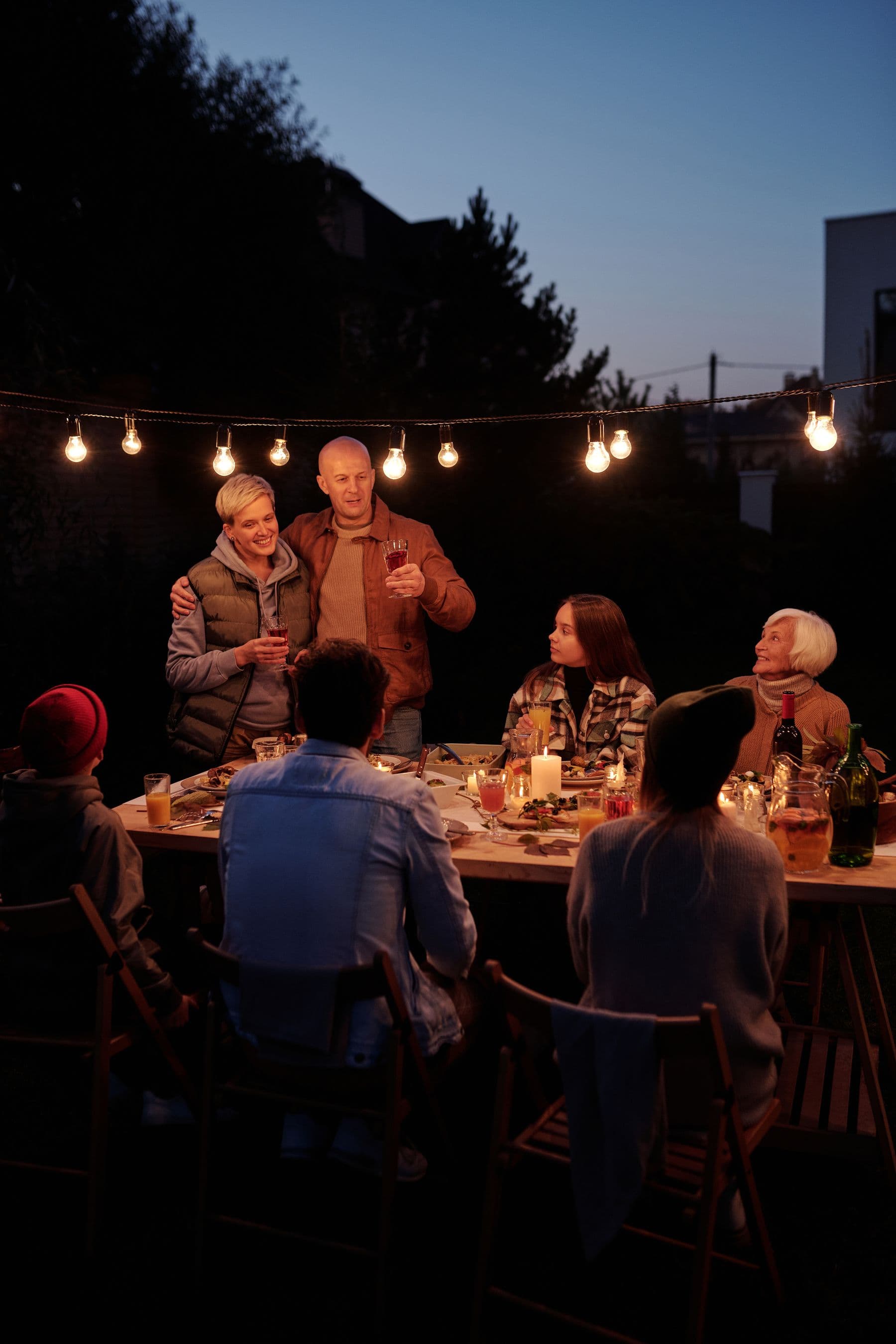 Long dinner table laid outdoors on a Marbella terrace at dusk